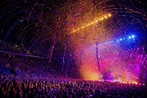Arena crowd celebrating beneath a professional confetti and streamer finale