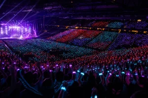 Arena audience illuminated by synchronized cyan red and violet LED wristbands