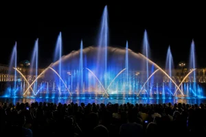 Choreographed blue and gold fountain show performing for an evening event audience